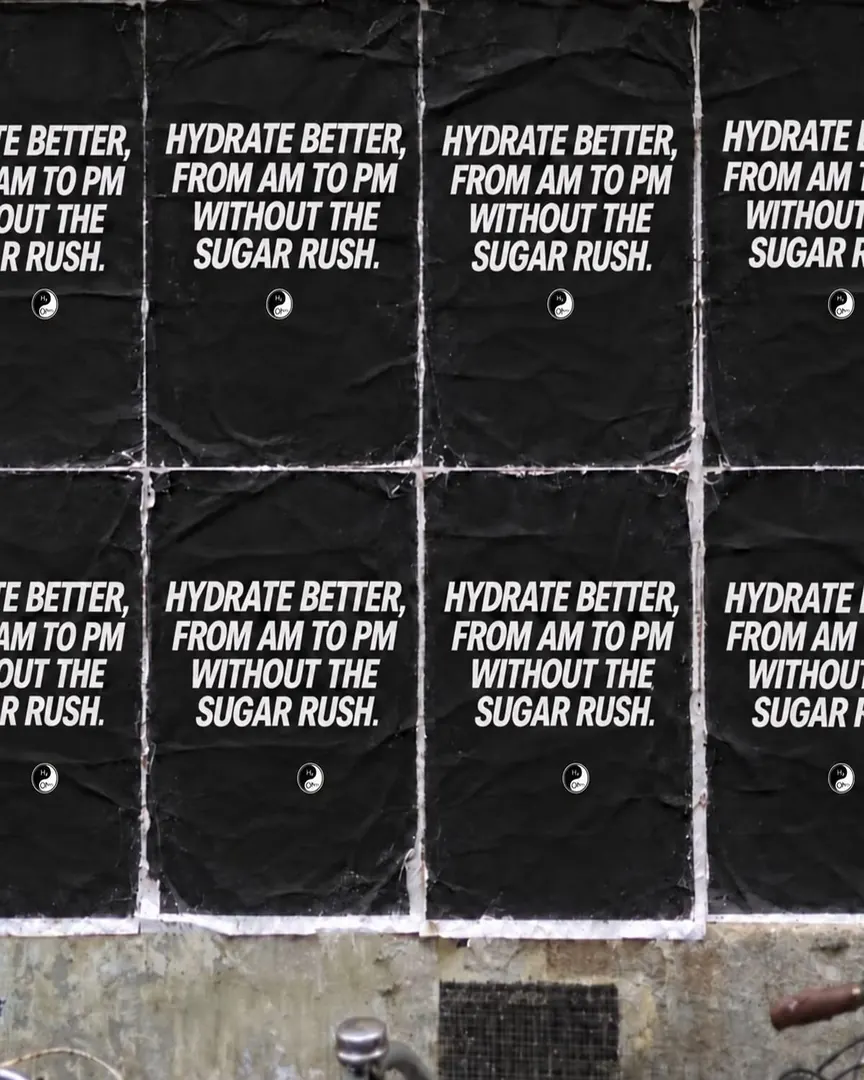 Wheatpaste posters reading Hydrate better, from AM to PM, without the sugar rush